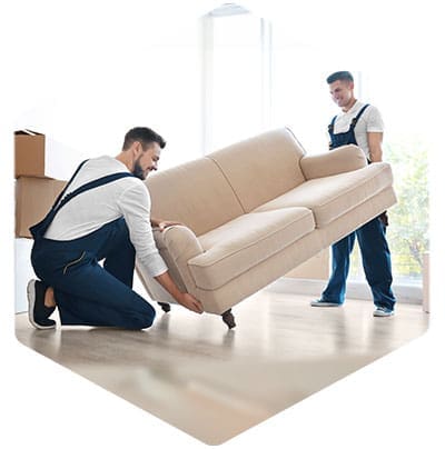 2 person delivery crew, carrying a sofa into a showroom