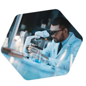 A medical researcher examining a sample under a microscope - DeliveryApp Medical Courier Services